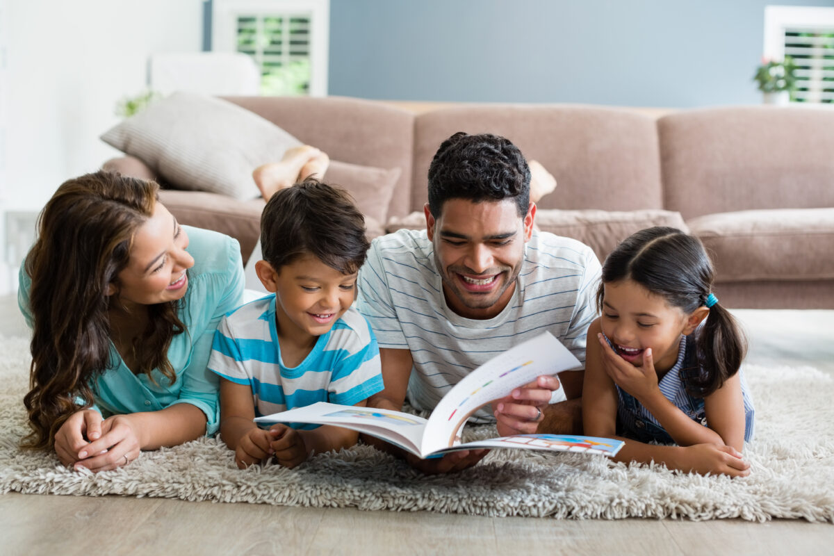 Familia lendo pais e filhos no chao Desperta Debora 1